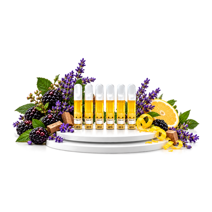 Six Johnny Apple CBD 1mL vape cartridges on a white platform with lavender, blackberries and lemon