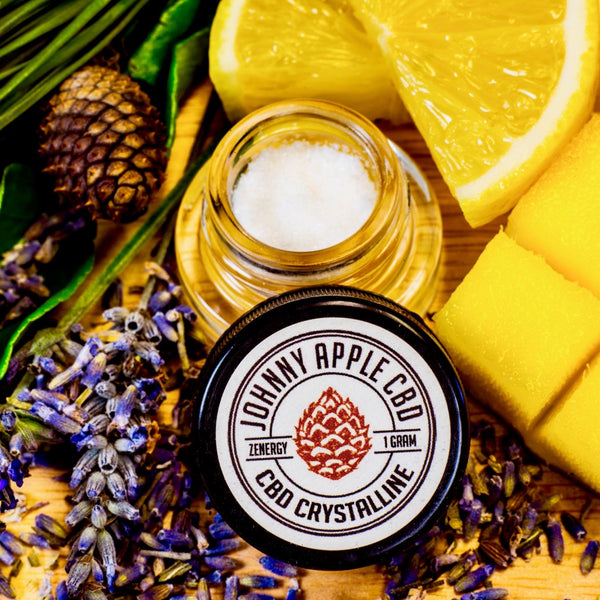 Johnny Apple CBD Zenergy Uplift crystalline jar beside an open jar of crystals, with lavender, lemon and mango